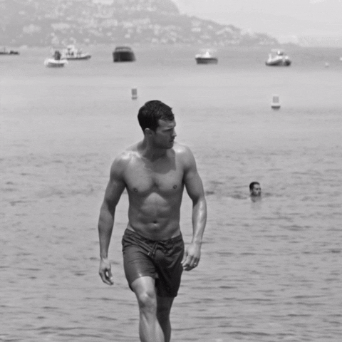 Confident Man Shoreline Stroll GIF