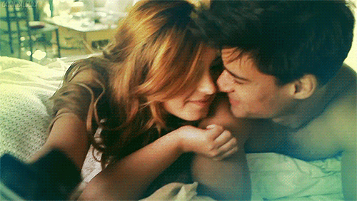 Couple cuddles while taking a selfie gif