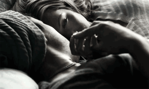 Couple Lying Together in Intimate Embrace GIF
