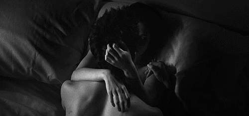 Couple stares into each other's eyes while cuddling gif