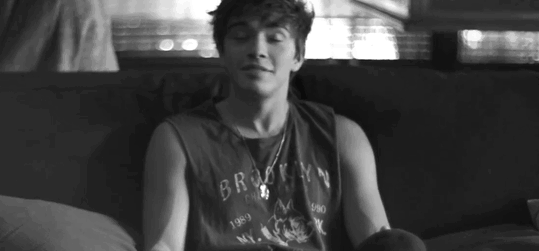 Cute couple cuddles on couch eating popcorn gif