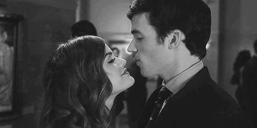 Flirtatious Couple Leaning In For Kiss GIF