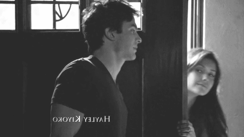 Flirtatious Doorway Peek GIF