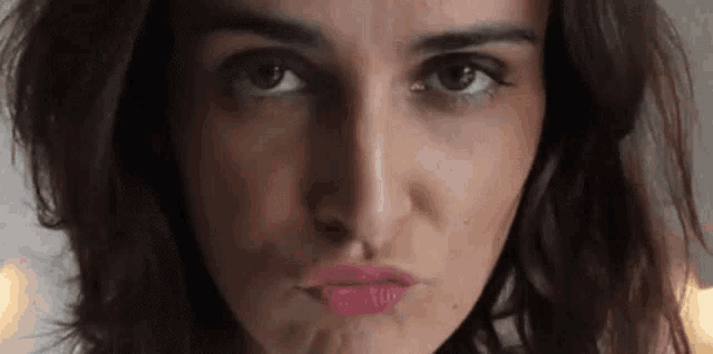 Flirtatious Woman Blows Kiss GIF