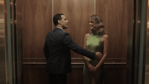 Flirty Couple Kissing In Elevator GIF