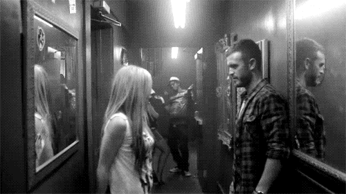 Flirty Couple Standing Close GIF