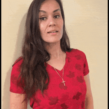 Flirty Woman Smiling Against Wall GIF
