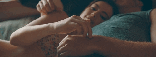 Gf walks her fingers up bf's arm while cuddling gif