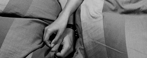 Intertwined Hands On Bed GIF