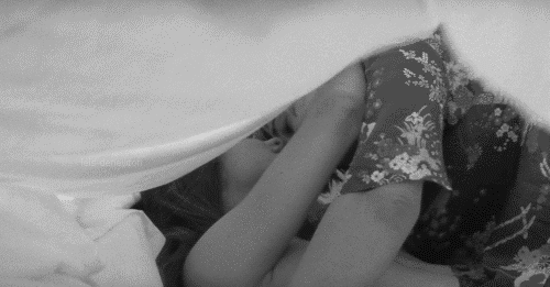 Intimate Couple Cuddling Under Blanket GIF