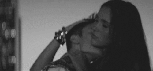 Man kisses women on her neck gif