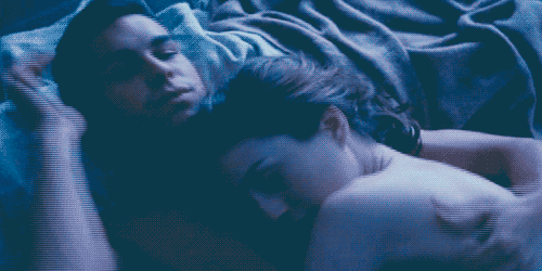 Man wraps his arms around woman while cuddling gif
