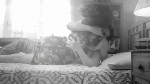 Passionate Couple Cuddling In Bed GIF