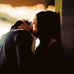 Passionate Couple Kissing Against Wall GIF