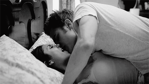 Passionate Couple Kissing Intimately On Bed GIF