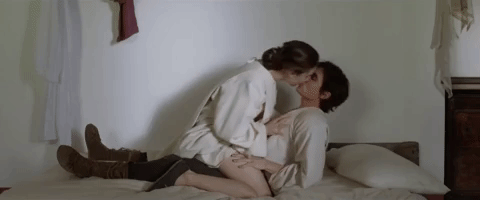 Passionate Lovers Kissing On Bed GIF