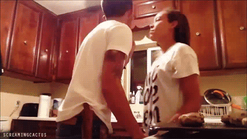 Playful Intimate Kitchen Kiss GIF
