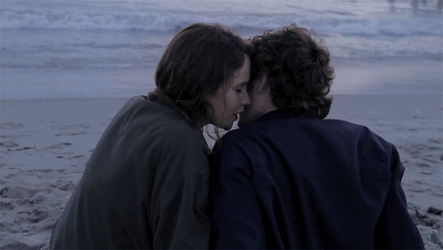 Romantic Couple Cuddling On Beach GIF