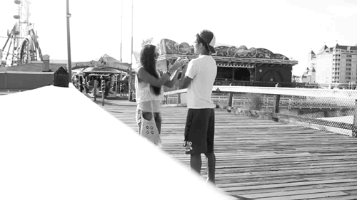 Romantic Couple Flirting On Boardwalk GIF