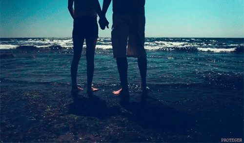Romantic Couple Holding Hands at Beach GIF