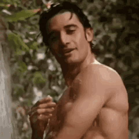 Sexy Man Smiles Flirtatiously In Shower GIF