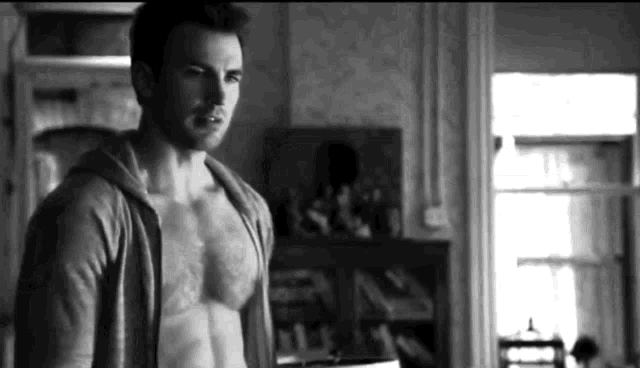 Sexy Man Unzips Shirt Flirtatiously GIF