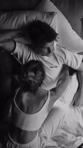 Woman crawls into bed to cuddle with her man