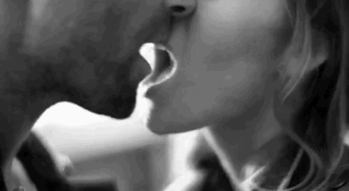 Woman kisses and bites her man's lips