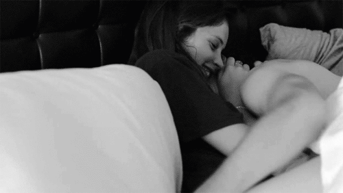 Woman Laughing While Cuddling Partner GIF