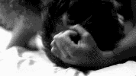 Woman massages back of man's head gif