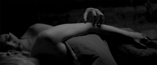 Woman rubs her man's arm while cuddling gif