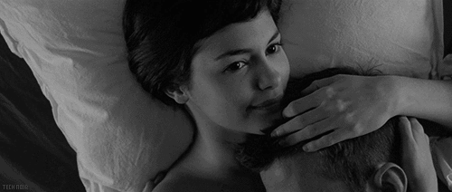 Woman smiles and rubs man's head while cuddling gif